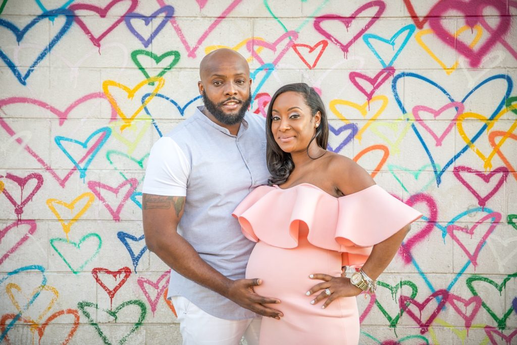 mom and dad by heart wall maternity session